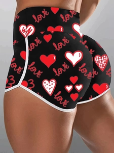 Detail of high waist slim fitness shorts with red heart print and white edge binding