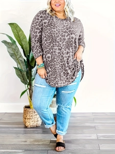 Loose leopard print long sleeve top paired with distressed denim jeans in a lifestyle setting