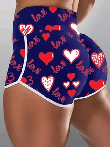 Detail of high waisted compression shorts with red heart and love prints on navy fabric