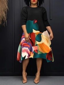 Plus size straight dress with black bodice and colorful abstract geometric print hem