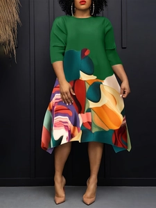 Detail of plus size dress with green bodice and colorful abstract asymmetric hemline