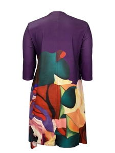 Rear view of plus size dress with purple top and colorful abstract print on the hem