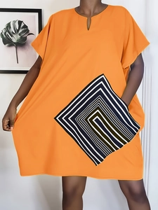 Detail view of bright orange plus size loose dress with geometric black and white stripes