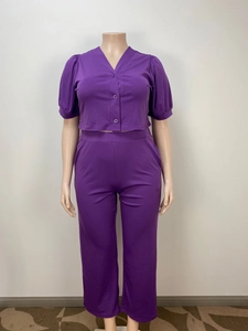 Detailed close-up of purple two-piece set with puff sleeves and button-down v-neck top