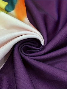 Macro detail of the smooth abstract print fabric with purple and orange gradient ink splash