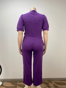 Detail of purple two-piece set featuring back view of short-sleeve top and trousers