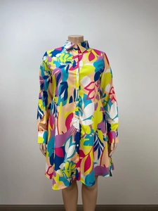 Detail of vibrant tropical leaf print on a loose-fitting long sleeve shirt dress
