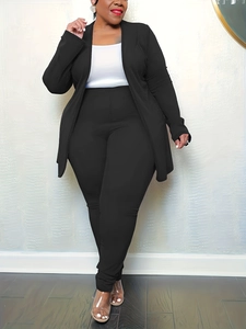 Detail showing high-stretch fabric texture on black cardigan and white base top