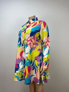 Detail of loose fit long sleeve floral print shirt dress with collar and white buttons