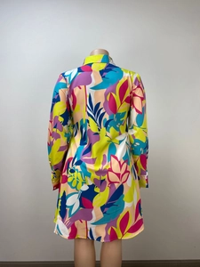 Detail view of the colorful tropical leaf print and smooth woven fabric on shirt dress