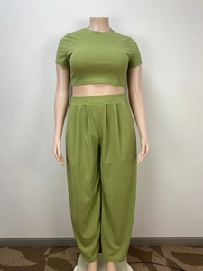 Detail of olive green two-piece lounge set with crop top and pleated wide-leg pants