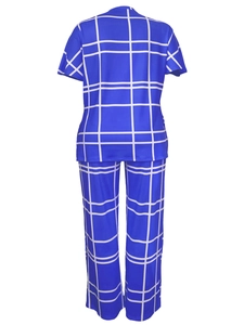 Rear view of royal blue two-piece pajama set with white grid pattern on short sleeve top