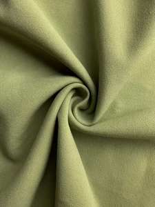 Macro shot of olive green woven fabric with a fine matte texture and high density finish