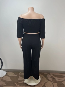 Rear view of comfortable black two-piece set featuring off-shoulder top and wide-leg trousers