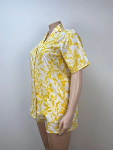 Detailed close-up of a women's summer two-piece set featuring yellow floral prints