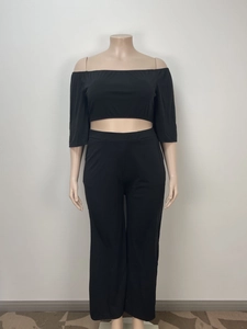 Detail of black two-piece off-the-shoulder set with wide-leg pants for a loose fit