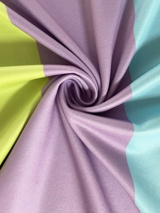 Detailed view of striped satin fabric showing purple, green, and blue silky texture