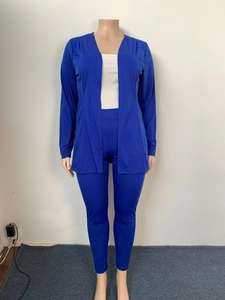 Detail of the royal blue knit three-piece set featuring V-neck cardigan and matching pants