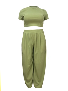 Detail of avocado green two-piece casual set featuring crop top and pleated wide-leg pants