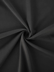 Detailed view of black knitted fabric texture showing soft drape and spiral pattern