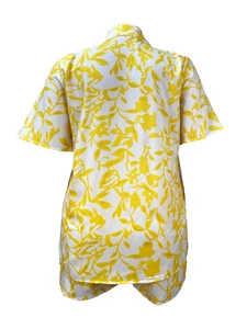 Detail view of lightweight white short-sleeved shirt with yellow leaf pattern print