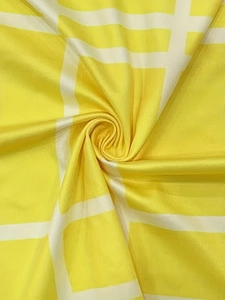 Detail of yellow and white plaid fabric showing smooth texture and vertical weave pattern