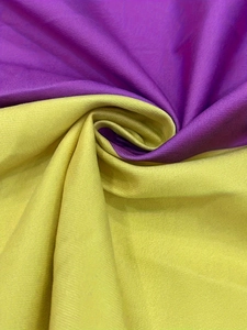 Detail of soft purple and lime green fabric texture with elegant pleated spiral effect