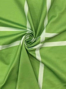Macro shot of green ribbed fabric with white plaid pattern showing fine texture and folds