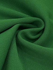 Detailed close-up showing the premium green knit fabric texture and fine weaving quality