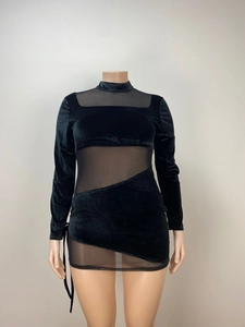 Detail of black velvet mini dress featuring sheer mesh cutouts and side tie accents