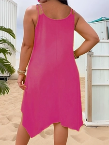Back view of a loose rose pink camisole dress with an irregular hem on a beach background
