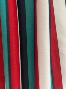 Detail shot of vertical striped fabric in red, dark green, and black with fine texture
