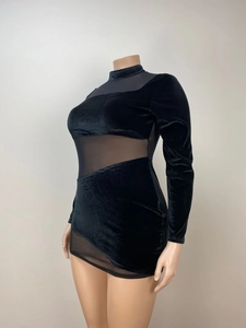Detail of black velvet mini dress featuring sheer mesh panels and long sleeves