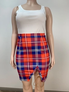 Detailed view of high-waisted red and blue plaid skirt with lace-up slit and tartan pattern