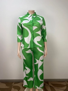 Close-up of green and white abstract print on casual two-piece shirt and pants set