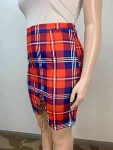 Detail of high waisted plaid mini skirt featuring red and blue patterns with side lace-up