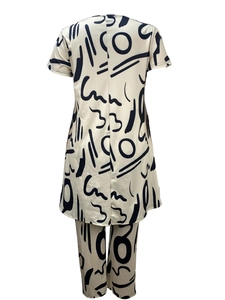 Detail showing high-quality white two-piece set with black abstract graffiti patterns