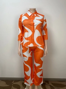 Detail of orange and white abstract pattern on long sleeve shirt and pants set