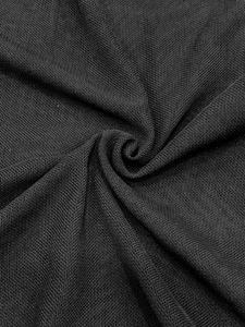Macro detail of high-quality black honeycomb mesh fabric with soft drape and texture