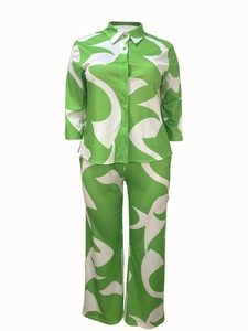 Detail of green abstract print two-piece set featuring button-up shirt and wide-leg trousers