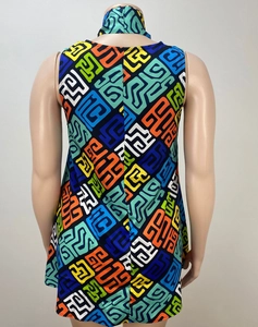 Detail of high neck sleeveless dress featuring vibrant colorful geometric abstract patterns