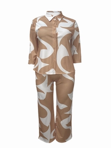 Close-up of khaki geometric print on button-down shirt and matching trousers set