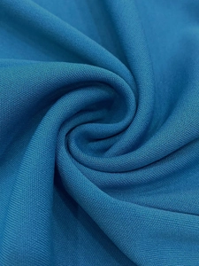 Close-up of the lake blue high-density knitted fabric with fine micro-mesh texture