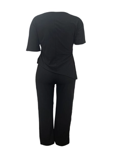 Detail view of the back of a casual black two-piece set with a loose fit and asymmetric hem