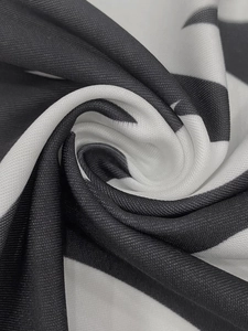 Detail shot of the black and white striped knit fabric showing texture and drape