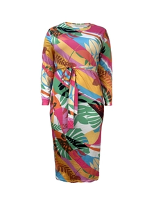 Detail of vibrant tropical leaf print dress with colorful patterns and matching belt