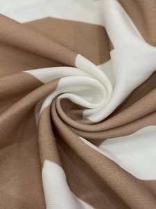 Detailed macro view of soft brown and white geometric block pattern fabric texture