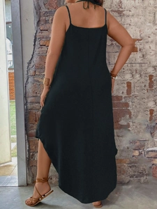 Detail of black backless long dress featuring thin straps and elegant flowing silhouette