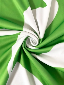 Detailed close-up of green and white printed fabric showing soft knitted texture