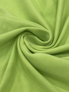 Macro view of breathable turquoise pique knit fabric texture for loose dress